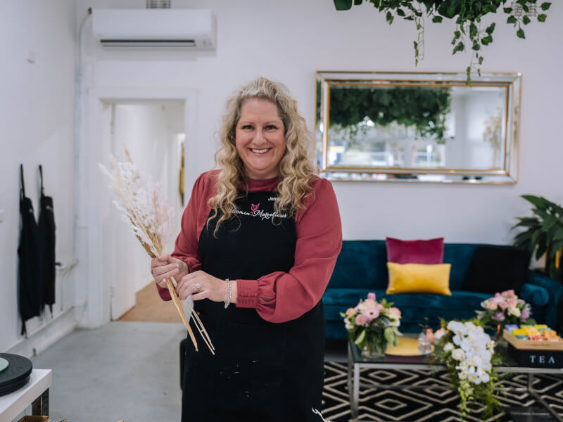 Woman holding dried flower at a floristry class. 
